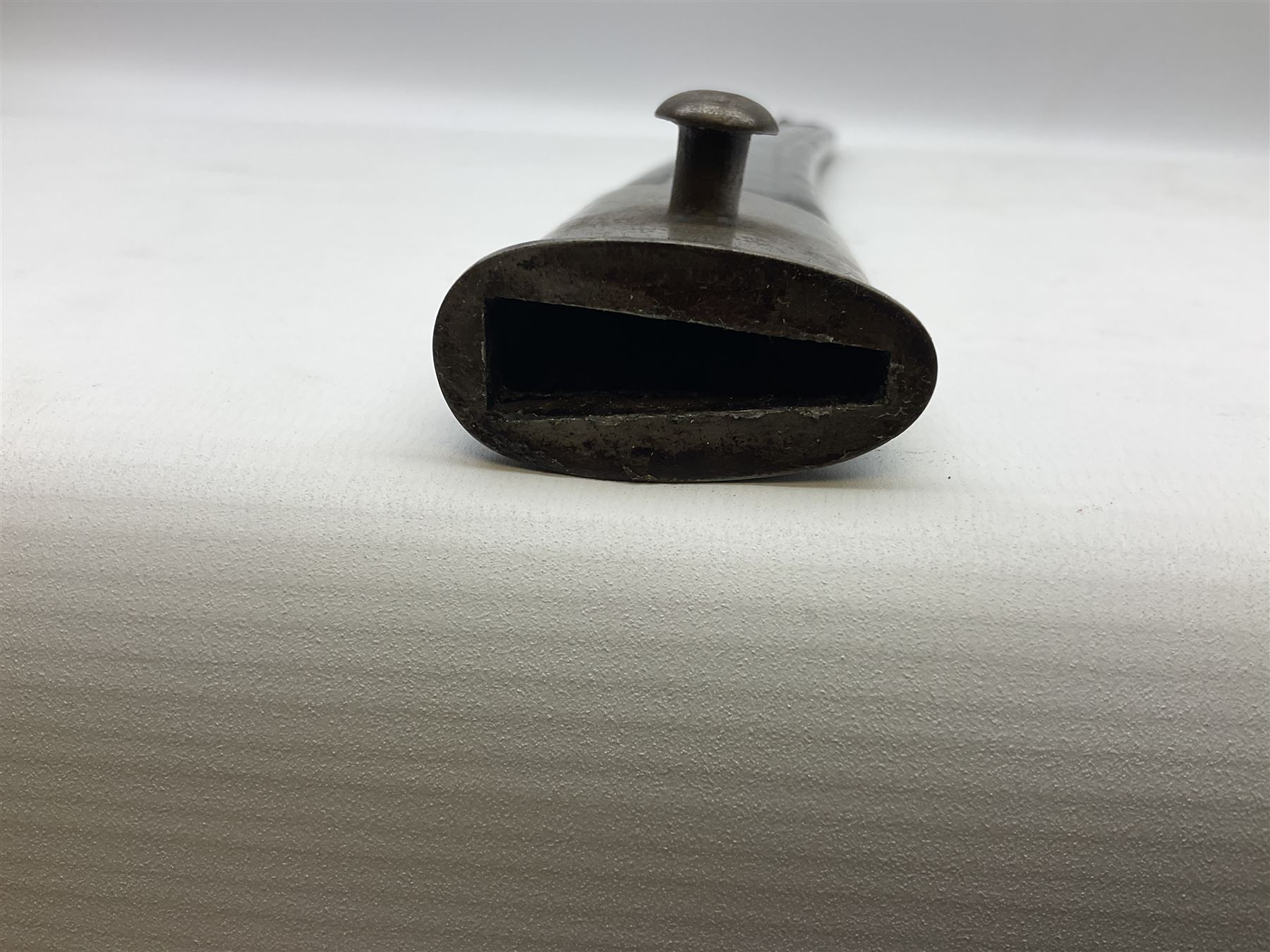 Turkish Model 1874 sword bayonet with 57.5cm curving steel fullered blade and chequered black grip, in steel mounted leather scabbard L75.5cm overall