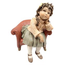 Italian Sibania Capodimonte figure of a young girl seated upon red chair with one hand supporting her head, with printed marks beneath, H24cm
