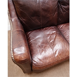  Two seat traditional sofa upholstered in brown studded leather, shaped back, serpentine front, turned supports, W158cm  