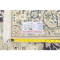 Central Persian Nain hand-knotted carpet, indigo field with central cusped medallion of radiating palmette form, enclosed with an elongated cartouche issuing network of scrolling vine work, arabesques and flowering sprays, surrounding ivory field of conforming design filled with foliate motifs and palmettes, spandrels of complimentary design with angular reserves, within principal border of ivory ground with scrolling vinery rosettes and arabesques, flanked by narrow guard stripes, with cotton fringe ends 