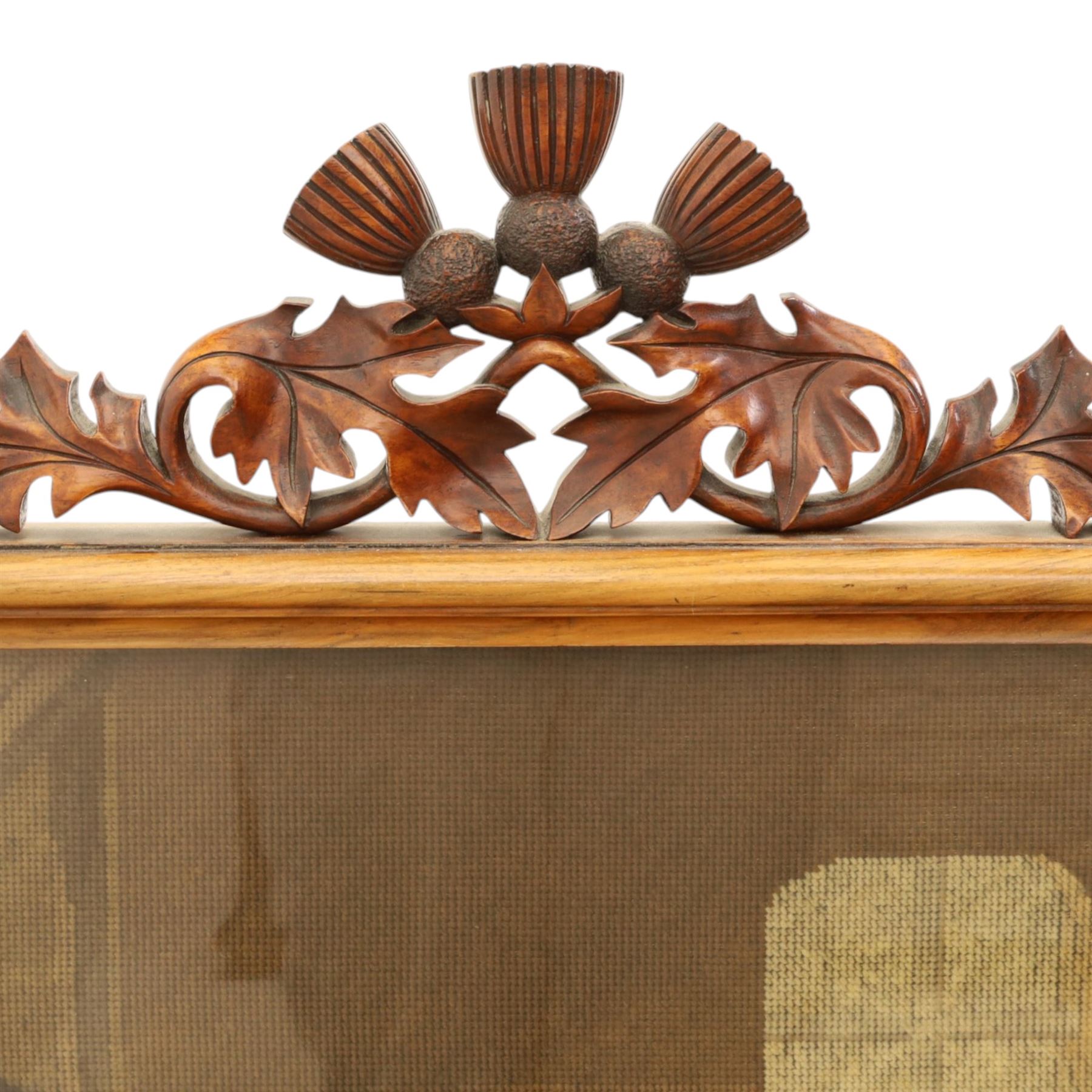Two Victorian fire screens, comprising mahogany pole screen with glazed floral woolwork panel on turned support and triform base (H 142cm, W 48cm); and a larger carved walnut tapestry fire screen, glazed panel depicting a domestic interior scene, scroll carved cresting, barley twist uprights and turned stretcher base (H 75cm, W 49cm)