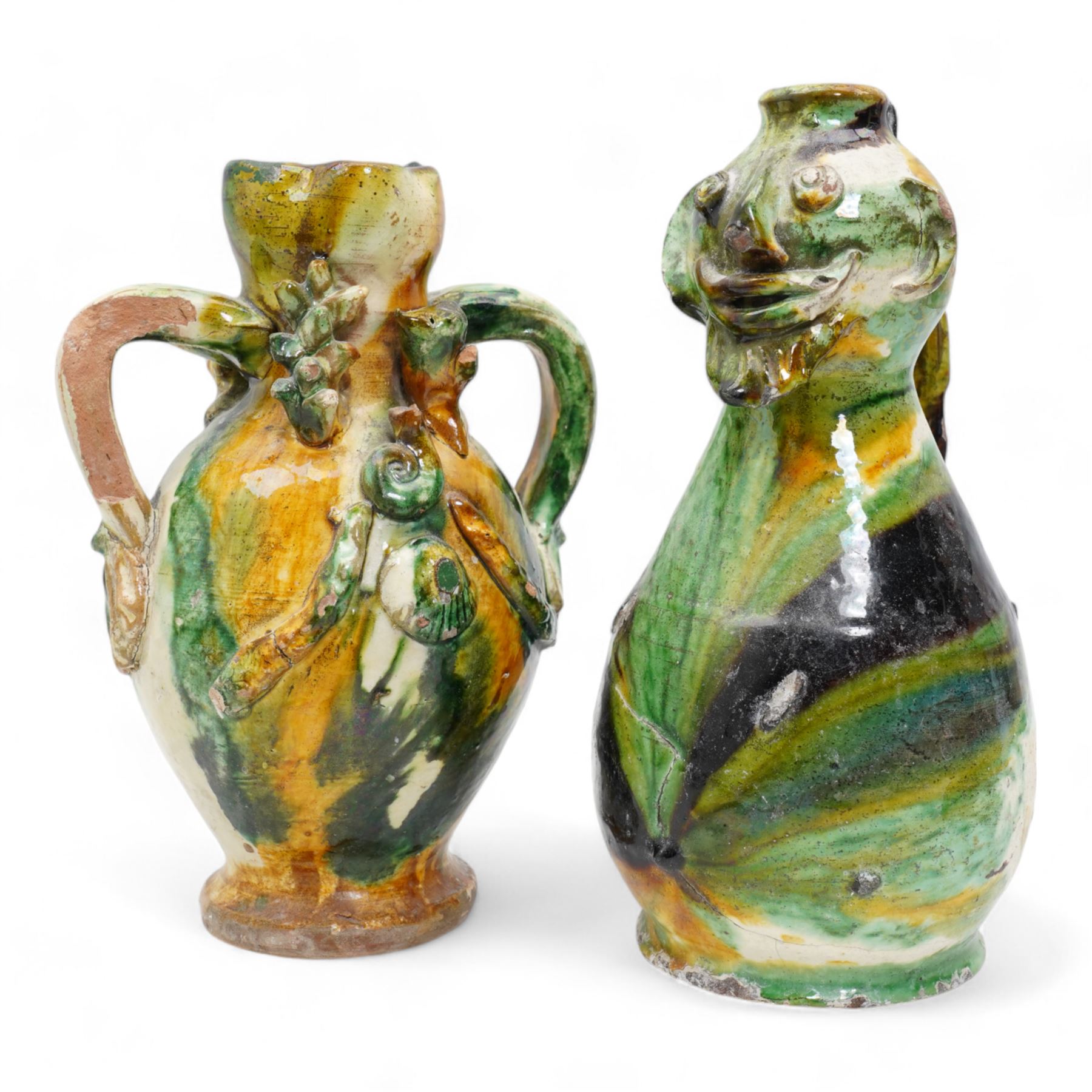 Two early 20th century Italian glazed terracotta wine flasks, one of twin handled form, applied with shells and insects, the other formed as a male figure, H24cm (2)