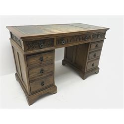20th century medium oak twin pedestal desk, three piece inset leather writing surface, eight graduating drawers, ogee bracket supports