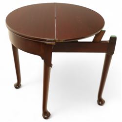 20th-century Georgian Revival style double fold-over card table, the first hinged circular top with polished mahogany surface above a second hinged circular top revealing a green baize playing surface with four counter-wells, underneath with a recessed compartment with and  chip and dice wells, the apron with fitted lock and key, raised on slender straight legs with pad feet 