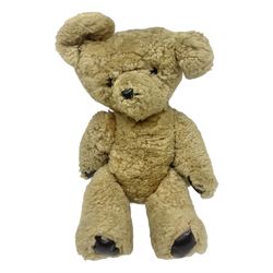 1950s sheepskin plush covered teddy bear with musical movement, the revolving head with applied eyes, leather nose and stitched mouth, jointed limbs with leather pads H50cm