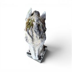 Large weathered cast stone horse head figure, raised on square plinth
