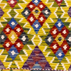 Afghan Maimana kilim flatweave runner, central field features large bold nested diamond motifs and stylized geometric lozenge patterns on olive purple, blue, and green tone ground, border stripe in teal ground, and fringe