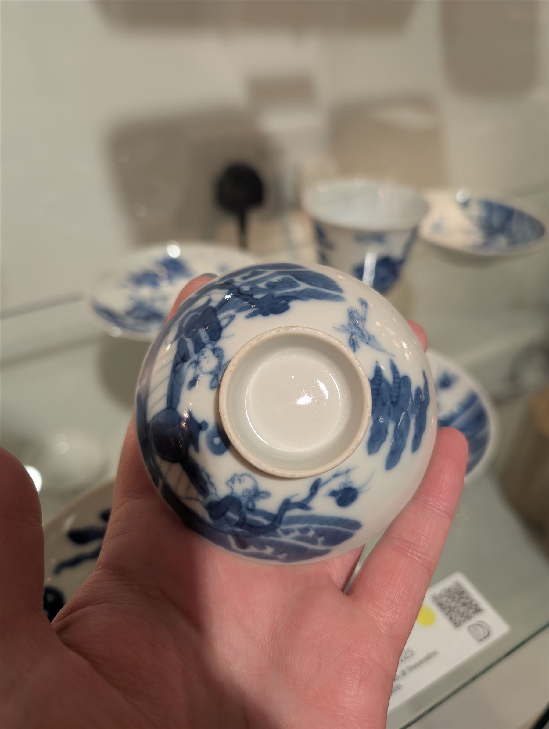 Pair of Chinese blue and white tea bowls, one with cover and four saucers, depicting two figures on a boat at sea, tea bowl H7cm