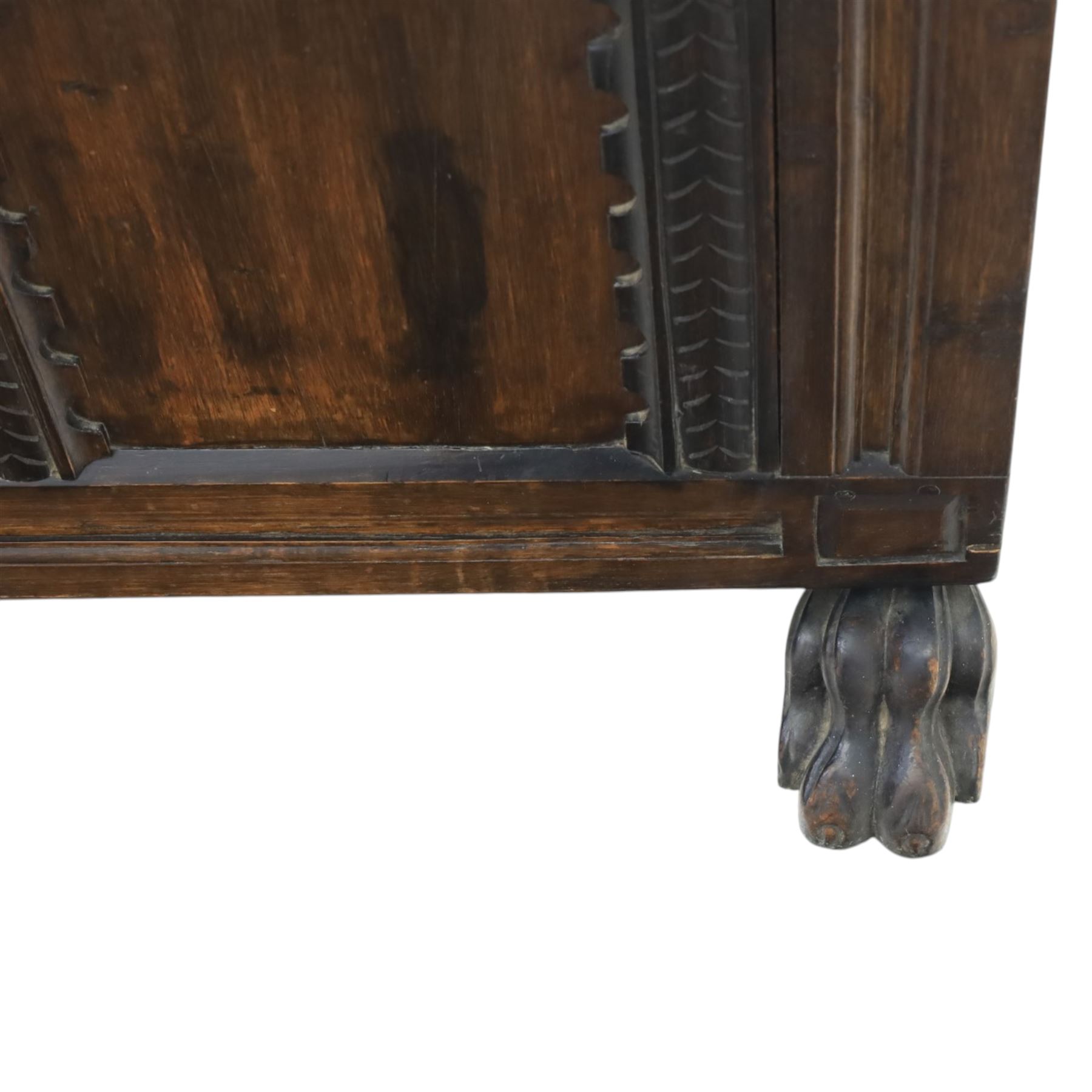 17th century design panelled oak blanket chest, hinged top above carved triple arch frieze, raised on individual carved claw feet