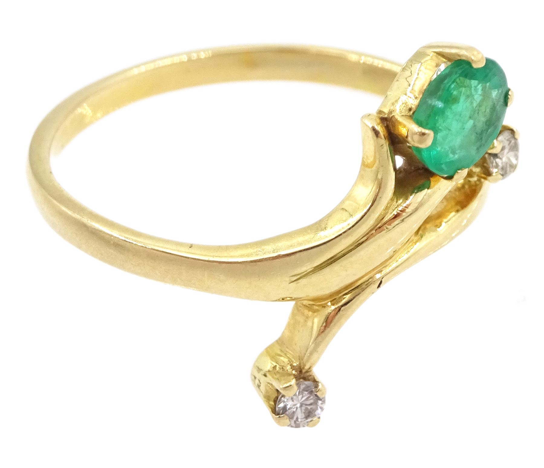 Gold three stone oval cut emerald and round brilliant cut diamond ring