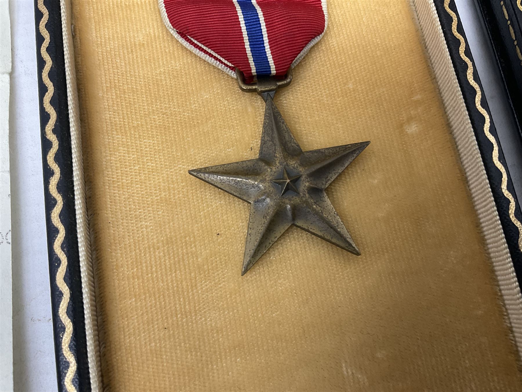 American Purple Heart Medal awarded to 32634848 Charles H. Poppo; cased with identity tags and paperwork; and Bronze Star Medal awarded to U.S. Marine Esteban T. Maranao; cased; American WWII Victory Medal and Asiatic Pacific Campaign Medal