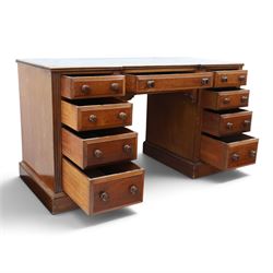 Victorian mahogany inverse breakfront twin pedestal desk, inset leather top over central drawer, flanked by pedestals with four graduating drawers, raised on a plinth base