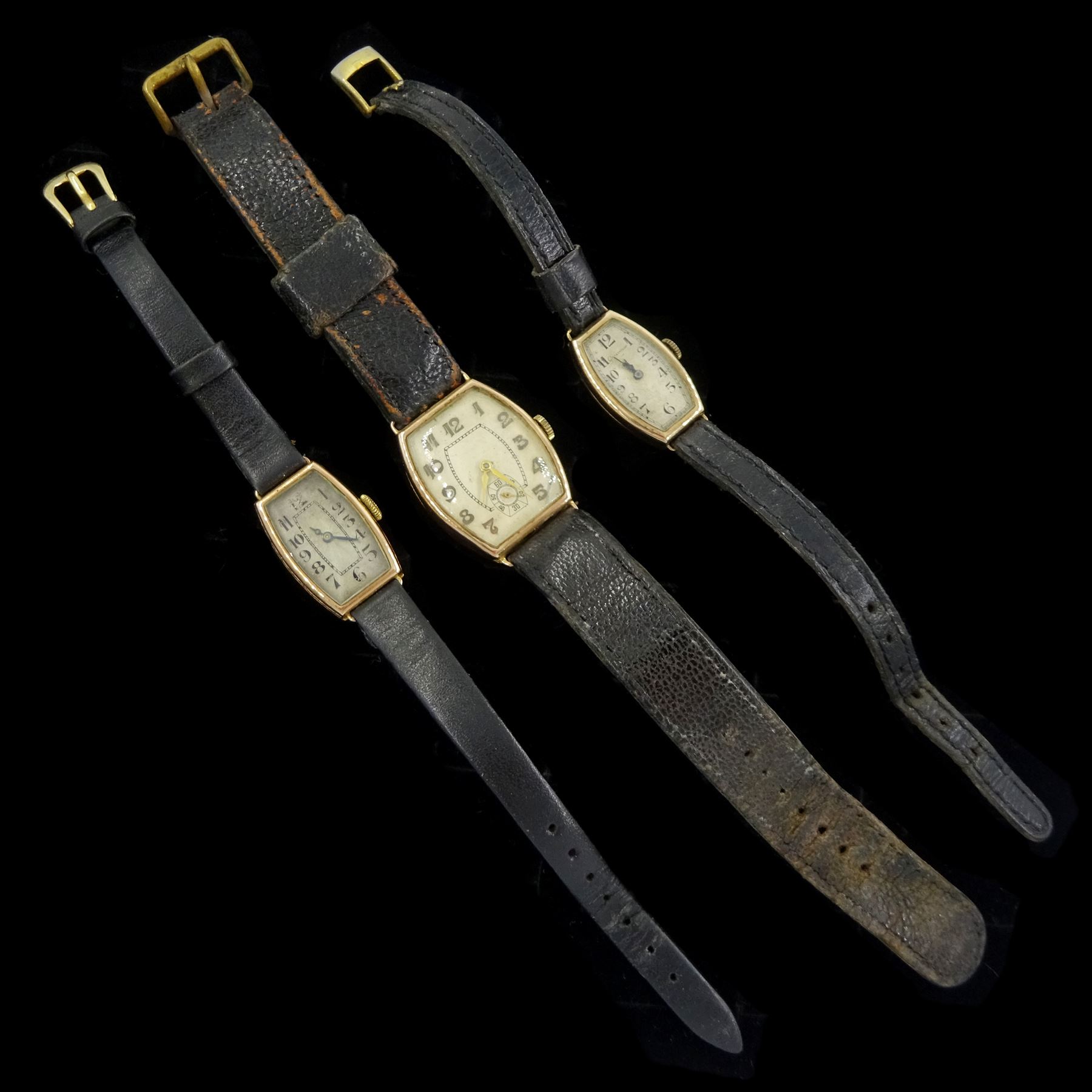 Three early 20th century 9ct gold, manual wind wristwatches, with cream and silvered dials, hallmarked, on leather straps