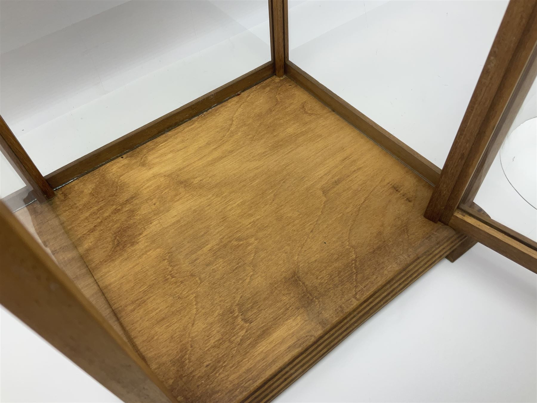 Tabletop glass display cabinet, with hinged door, together with two glass domes