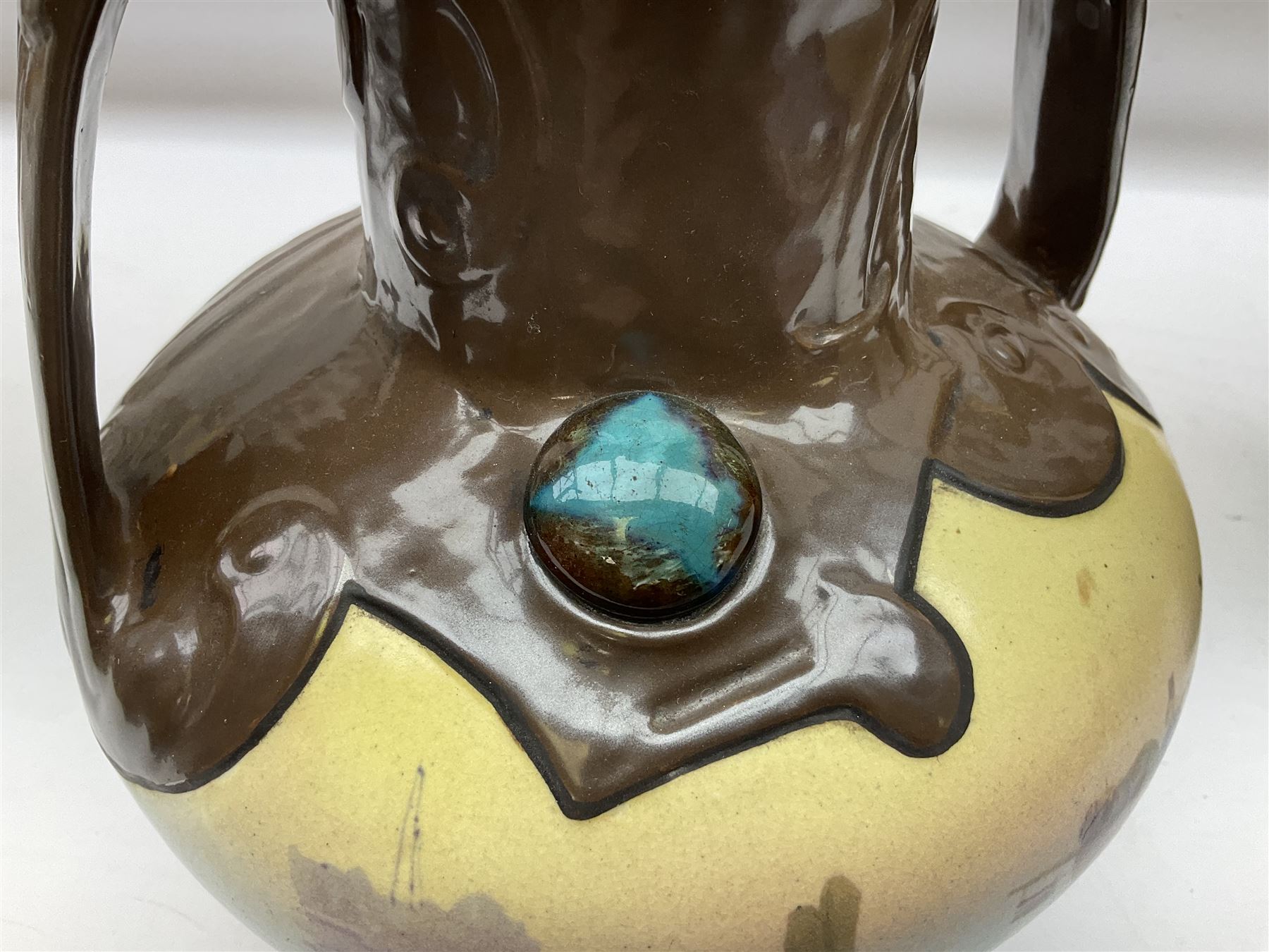 T. Forester Phoenix ware ewer of tapering form decorated with peacock and Bretby twin handled vase decorated with figures fishing in a boat sea scene