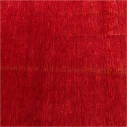 Two contemporary Moroccan Berber hand-woven rugs, deep madder red field of plain design, 199x153cm, other with deep madder red field with a simple lattice of ivory lines forming panels with some tonal variation, 190x146cm 