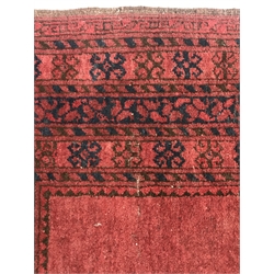  Afghan red ground rug, field decorated with Guls, repeating border, 204cm x 112cm  