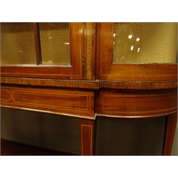  Edwardian inlaid mahogany display cabinet, shaped arched top, astragal glazed door enclosing lined interior with two shelves, square tapering supports joined by an undertier, spade feet, W132cm, H189cm, D38cm  