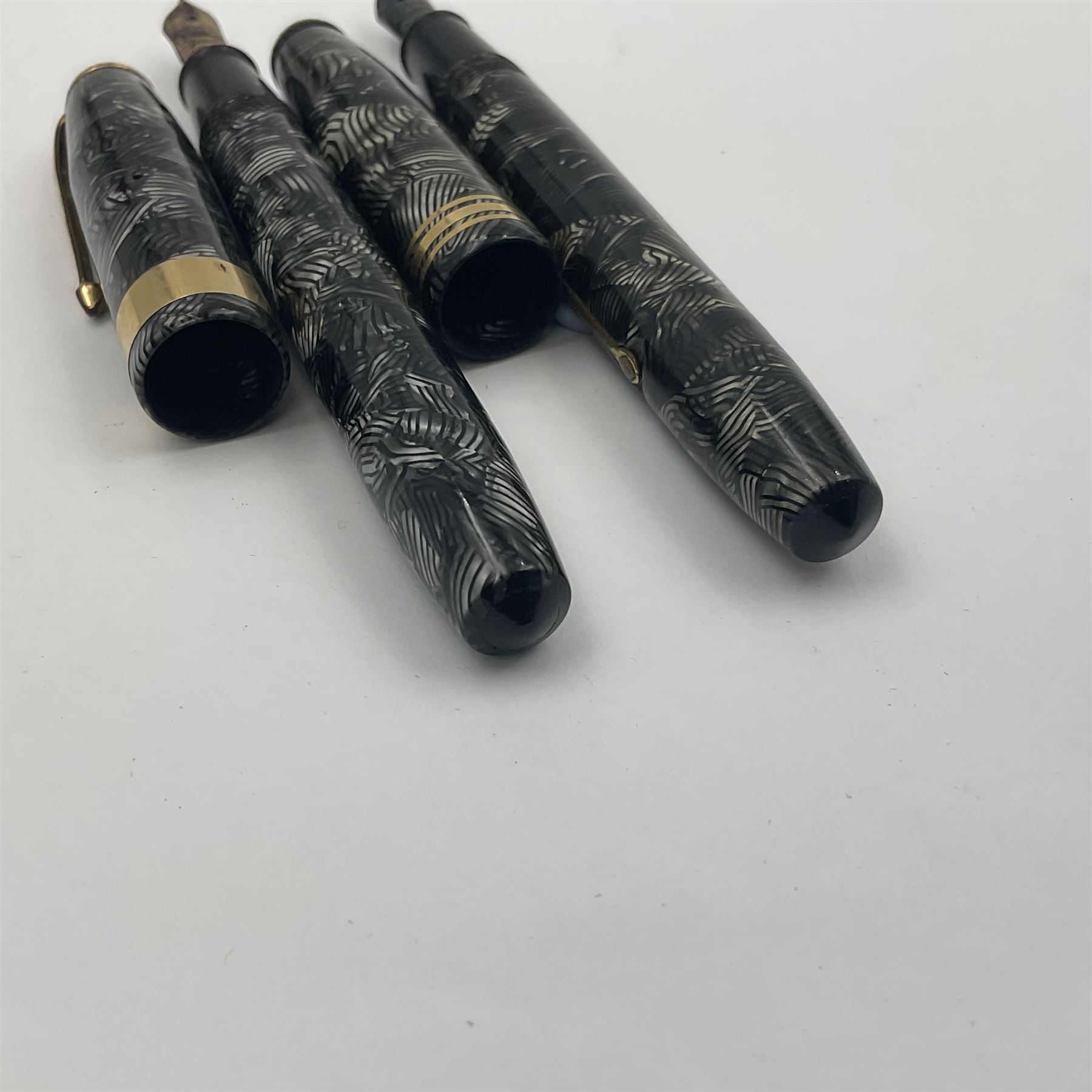 Conway Stewart Executive 60 fountain pen, the barrel and cap with hatched grey and black marble decoration and gold nib stamped Duro 14ct, together with a Conway Stewart 58 fountain pen similarly decorated in pearl blue and black with gold nib stamped 14ct, largest 13cm (2)