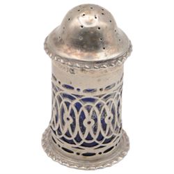 Late Victorian silver three piece cruet set, comprising open salt, pepper pot and mustard pot with cover, all with pierced decoration and upon four bun feet, hallmarked John Charles Lowe, London 1899 and 1900, salt with different maker's mark worn and indistinct, all with blue glass liners