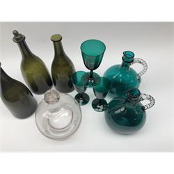 A group of 19th century glassware, comprising three green bottle glass bottles of mallet form, a pair of green glass ewers, three green glass wine glasses, and a clear glass fly catcher. 