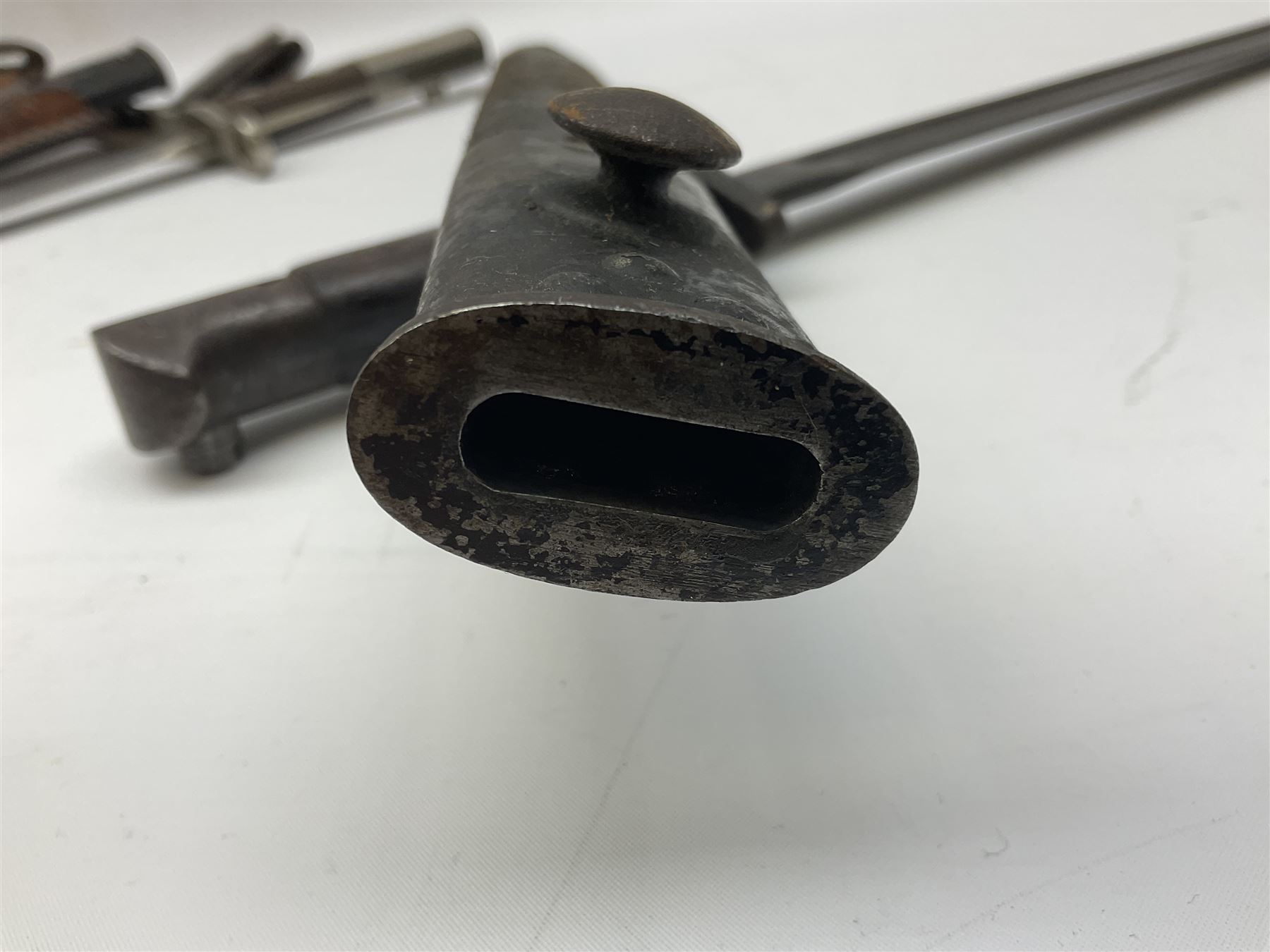 British Enfield 1907 model SMLE bayonet, with 43cm fullered steel blade and metal mounted leather scabbard L58cm overall; and Schmidt-Rubin Model 1918 bayonet the 30cm steel blade marked Elsener Schwyz No.579722; in steel scabbard with leather frog marked G. Bertolini Sellaio Vira/G.Tic 79 L45cm overall (2)