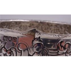 Late Victorian silver rose bowl, of circular form with embossed foliate and C scroll decoration, and engraved personal dedication, upon a part fluted spreading circular foot, hallmarked Wakely & Wheeler, London 1898, H11.5cm D18cm, approximate weight 11.67 ozt (363.2 grams)