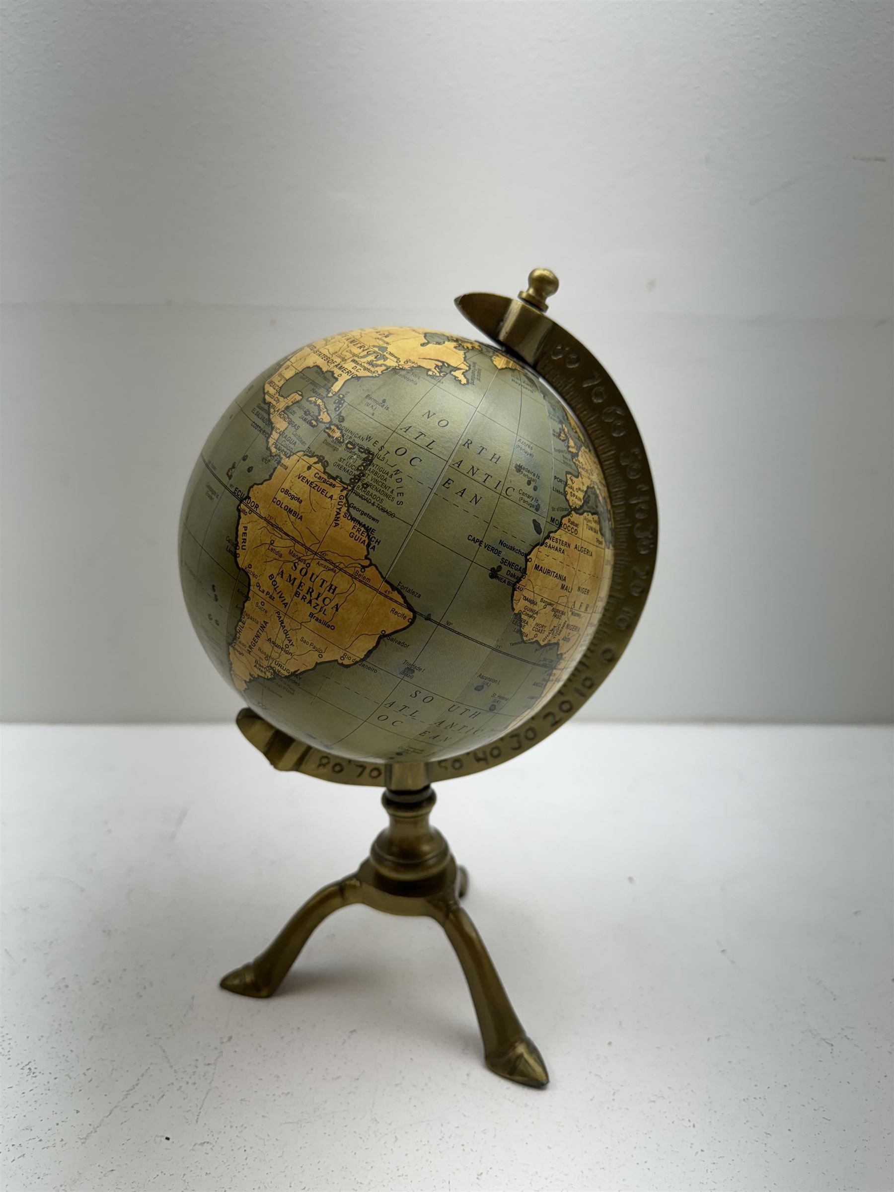 Terrestrial globe, raised on a tripod base, H30cm