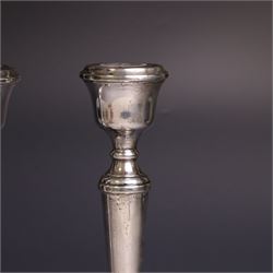 Pair of late 20th century silver candlesticks, each with tapering stem and upon circular beaded weigthed foot, hallmarked A T Cannon Ltd, Birmingham 1970, H21cm