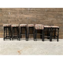 Seven tall bar stools with upholstered seat