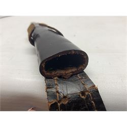 Third Pattern Commando Knife or Dagger with 17.5cm flattened diamond section blade and regulation black painted ribbed copper hilt with brass pommel nut; stamped William Rodgers Sheffield England to the cross-piece; in black painted brass mounted leather scabbard L34.5cm overall