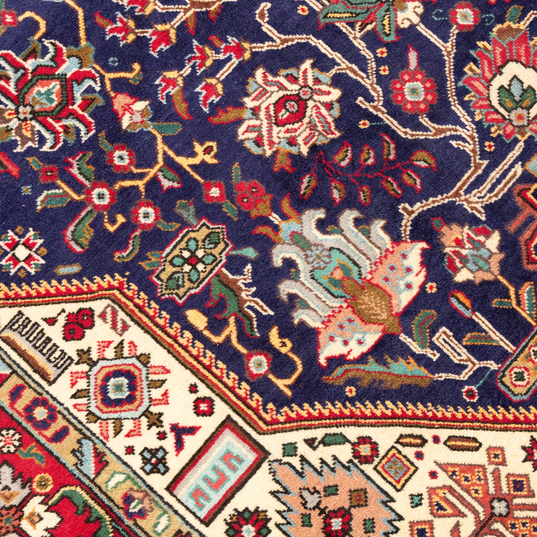 North West Persian carpet, the indigo field centred by a large terracotta and ivory medallion with matching pendants, decorated throughout with stylised palmettes, flowerheads and branching foliage, ivory geometric floral spandrels, enclosed by a red palmette border and narrow patterned guard bands