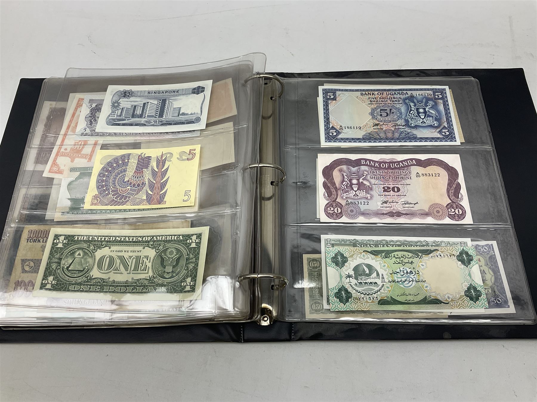 World banknotes, including Queen Elizabeth II The States of Jersey one pound 'DB202703', five pounds 'BB527762' and ten pounds 'AB651481', reserve bank of New Zealand two dollars '1L3 741894', King George V Straits Settlements one dollar 1st January 1935 'F/83 28924', various Bank of England notes etc, housed in two ring binder albums