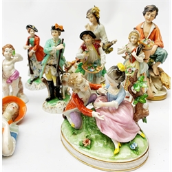  A group of assorted figurines, comprising a Royal Doulton figurine The Bedtime Story Hn2059, a pair of Dresden figurines modelled as male and female hunters, four assorted Sitzendorf figurines, four Capodimonte putto, a Capodimonte figure group, a near pair of Capodimonte bisque figurines, another unmarked bisque figurine, two pin cushion dolls, three Spanish figurines, two marked Nao, the other Zaphir.  