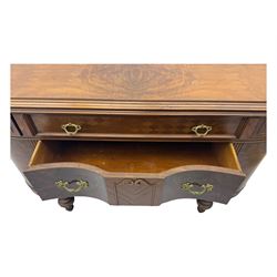 Late 20th century Italian walnut sideboard, serpentine front and bow-shaped top with highly figured veneer, single checkered-pattern frieze drawer over two drawers with central foliage cartouche, flanked by hinged frieze drawers over cupboards, on turned and carved supports