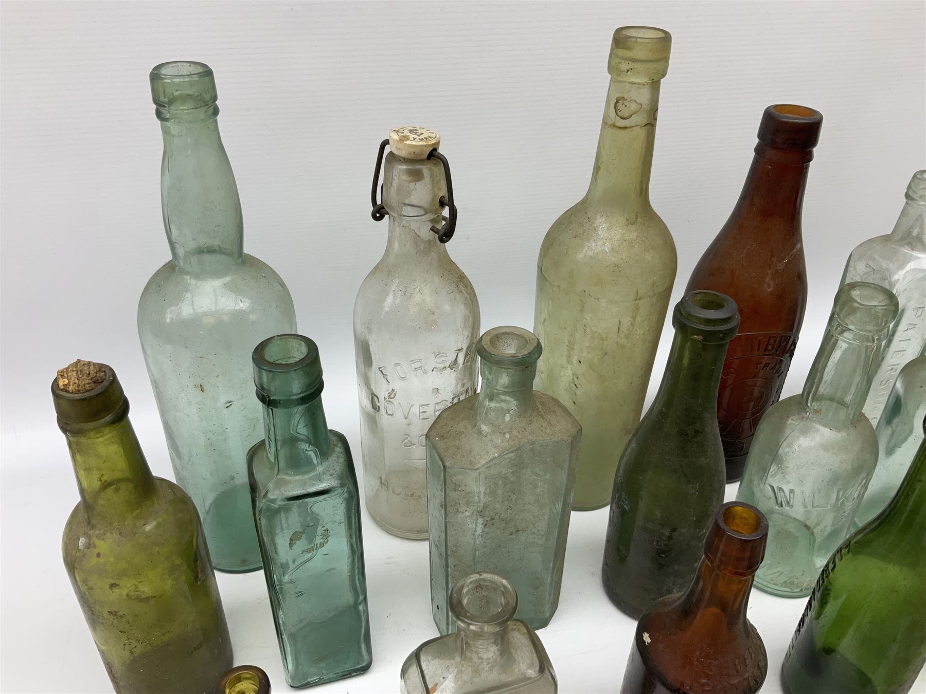 Collection of various vintage glass bottles and stoppers, including advertising bottles, sauce bottles and medical bottles etc