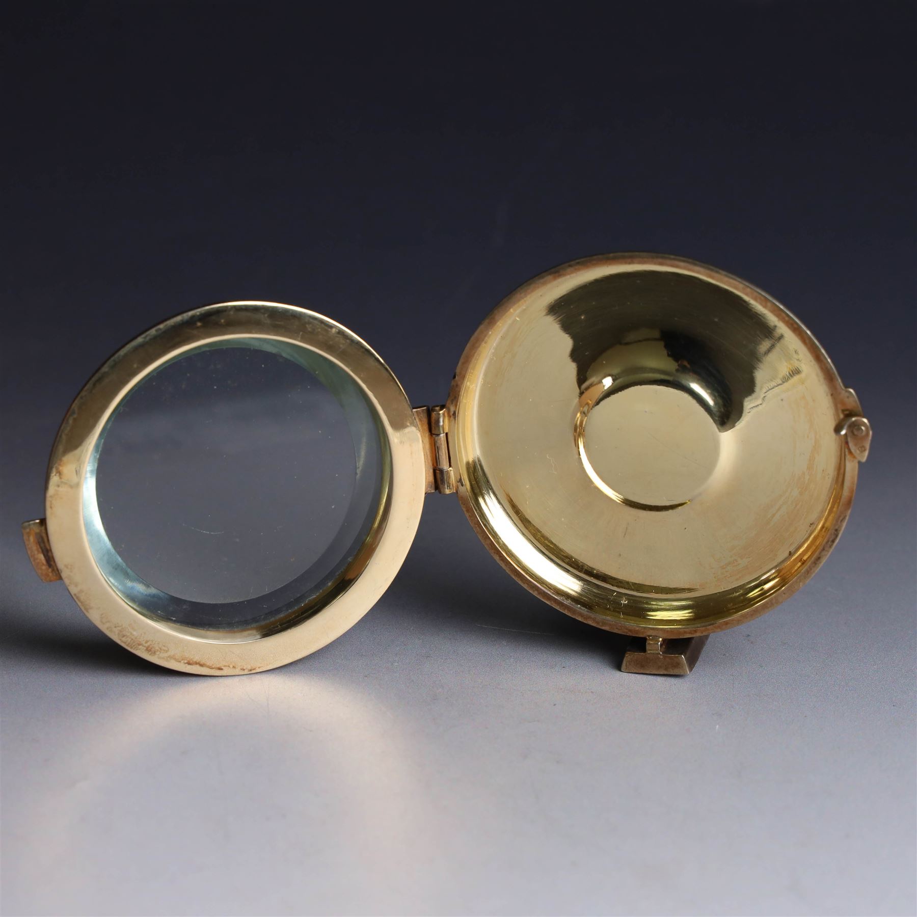 Late 20th century silver-gilt lunette, of circular form with bevelled glass centre, hallmarked Hayes & Finch Ltd, Birmingham 1977, H7.5cm