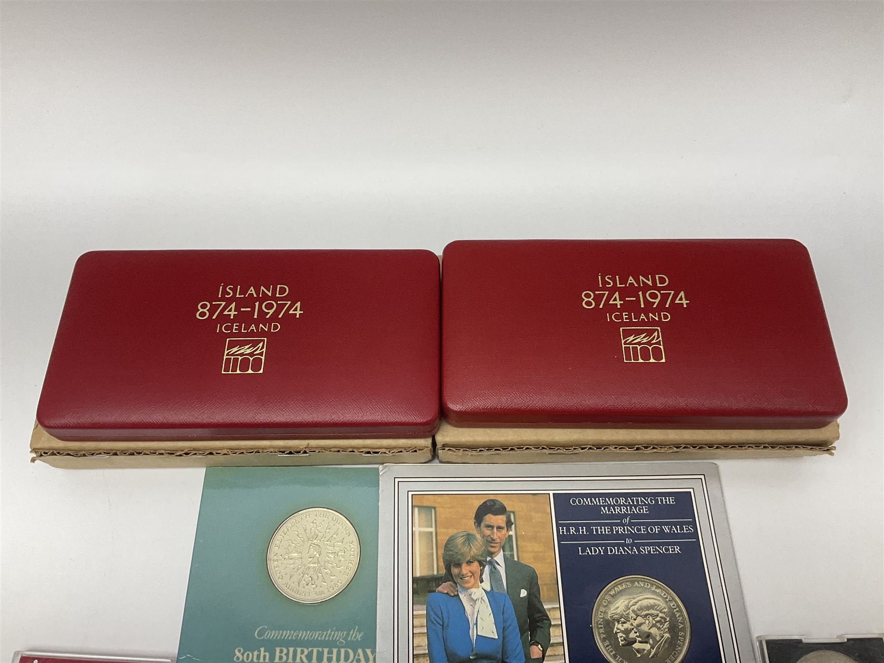 Coins including two King George VI 1951 Festival of Britain crowns each in green case, various other commemorative crowns, two Iceland '874-1974' two coin sets both in original red cases etc