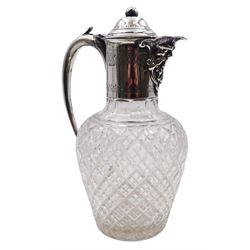 Edwardian silver mounted claret jug, the ovoid clear cut glass body with silver mounted collar with Bacchus mask spout, domed cover with ball finial and curved handle, hallmarked Sheffield 1903, makers mark FW, probably Frank Wood, H22cm