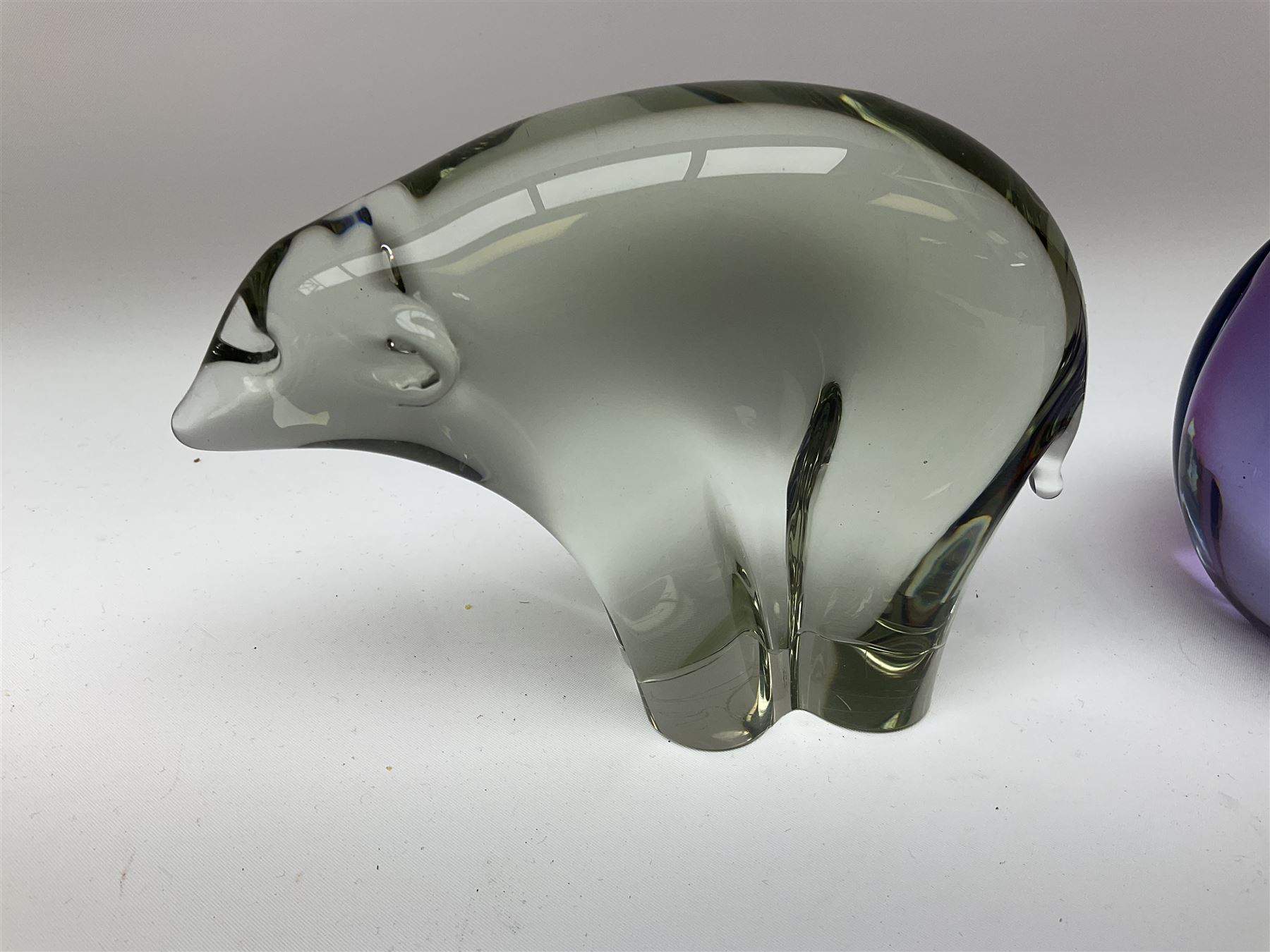 Livio Seguso (Italian, 1930-), Murano glass penguin paperweight in purple and blue, H12.5cm, together with another paperweight modelled as a polar bear for Graglas of Germany, c1970, both with etched marks beneath