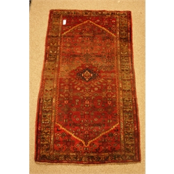  Red ground Persian rug,, hooked lozenge field with repeating border, 197cm x 110cm  