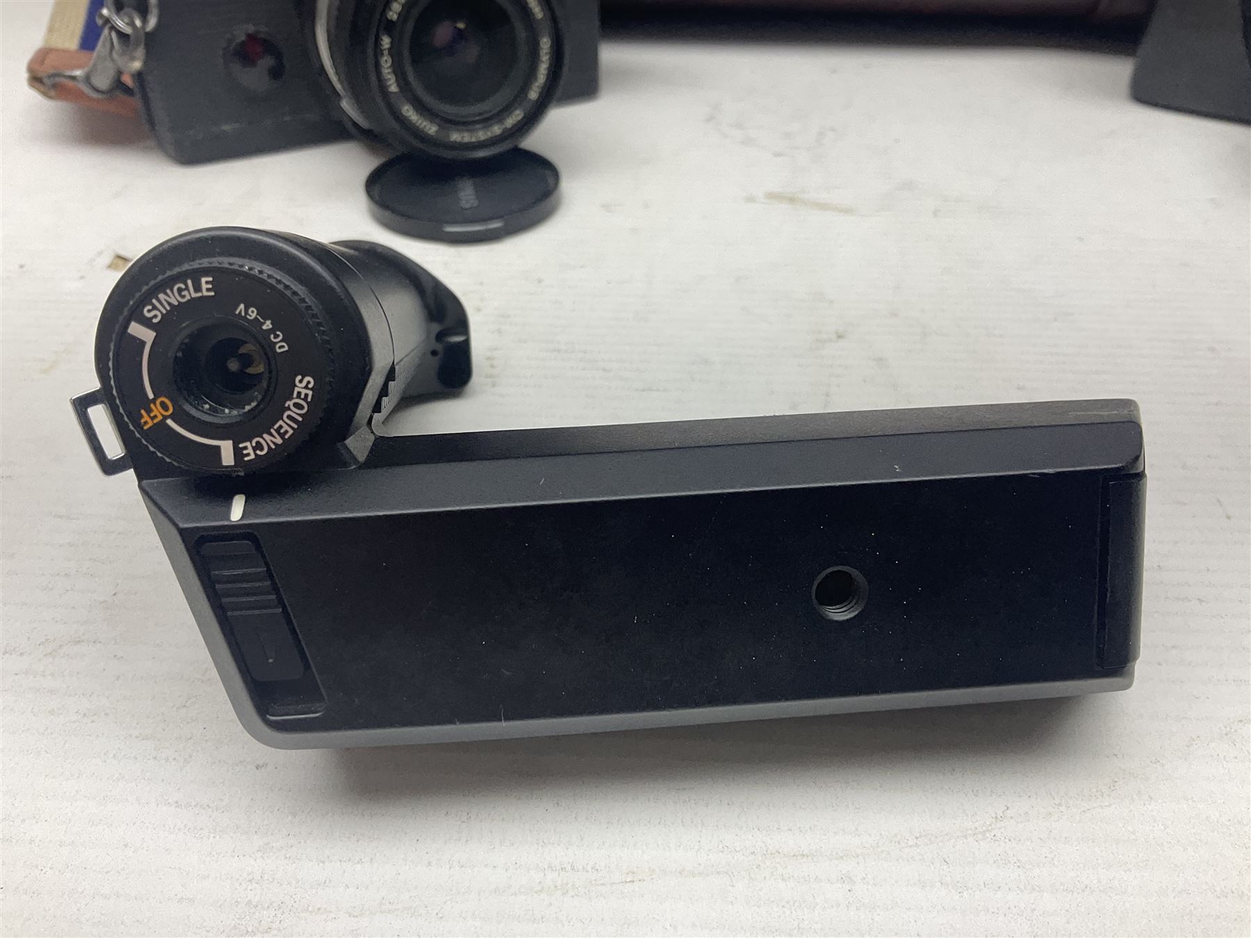 Olympus OM-2 camera body, serial no 1117526, with Olympus OM-System Zuiko Auto-W 28mm 1:2.8'  lens serial no 336591, Olympus OM10 camera body serial no 2392257, with Olympus OM-System Zuiko Auto-Macro 50mm 1:3.5' lens serial no 225784, Soligor C/D mirror lens 1:8 f=500mm' serial no 784035650 together with other camera equipment 