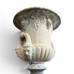 Cast stone classic garden urn, the rim decorated with leaves and berries, twin handles with face masks, raised on square base, stamped HGC