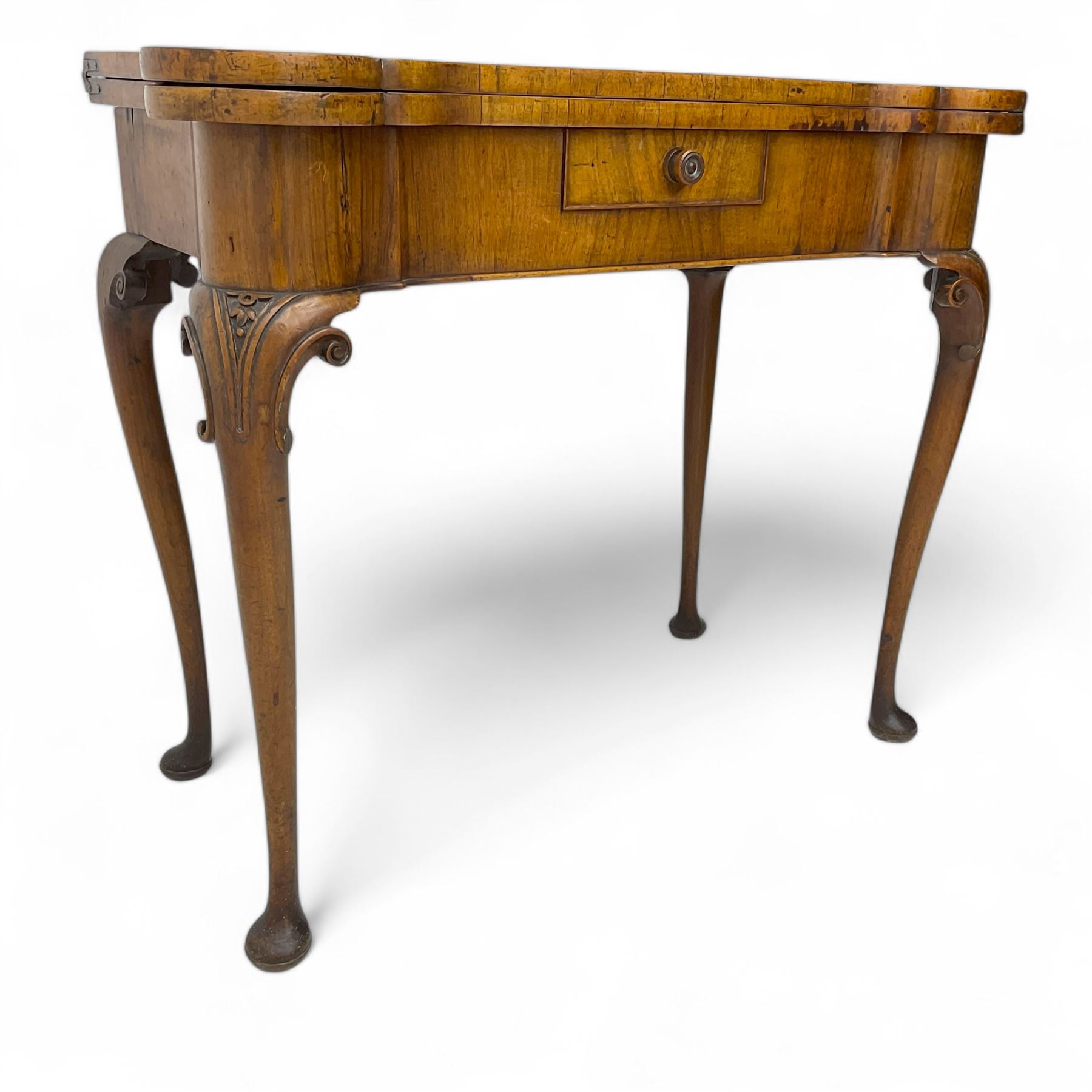 Georgian walnut fold-over card table, shaped rectangular top opening to reveal a baize-lined surface, supported by a concertina pull-out rear mechanism, frieze fitted with single drawer, raised on cabriole supports with foliate carvings terminating in pad feet