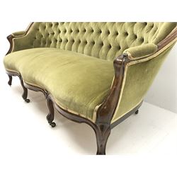 Victorian mahogany framed three seat settee, upholstered in deeply buttoned green fabric, cabriole shaped supports, brass castors