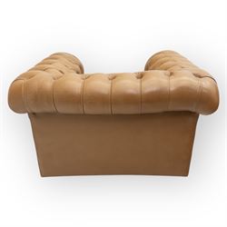 Contemporary set of two tan leather armchairs, comprising a deep-buttoned chesterfield and a matching wingback chair, both with rolled arms, studded borders