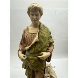 Pair of Royal Dux figures, no. 1115, modelled as a shepherd with a goat by his side and a shepherdess feeding a lamb, each wearing flowing green and pink robes with gilt detailing, with pink triangle mark beneath, H51cm