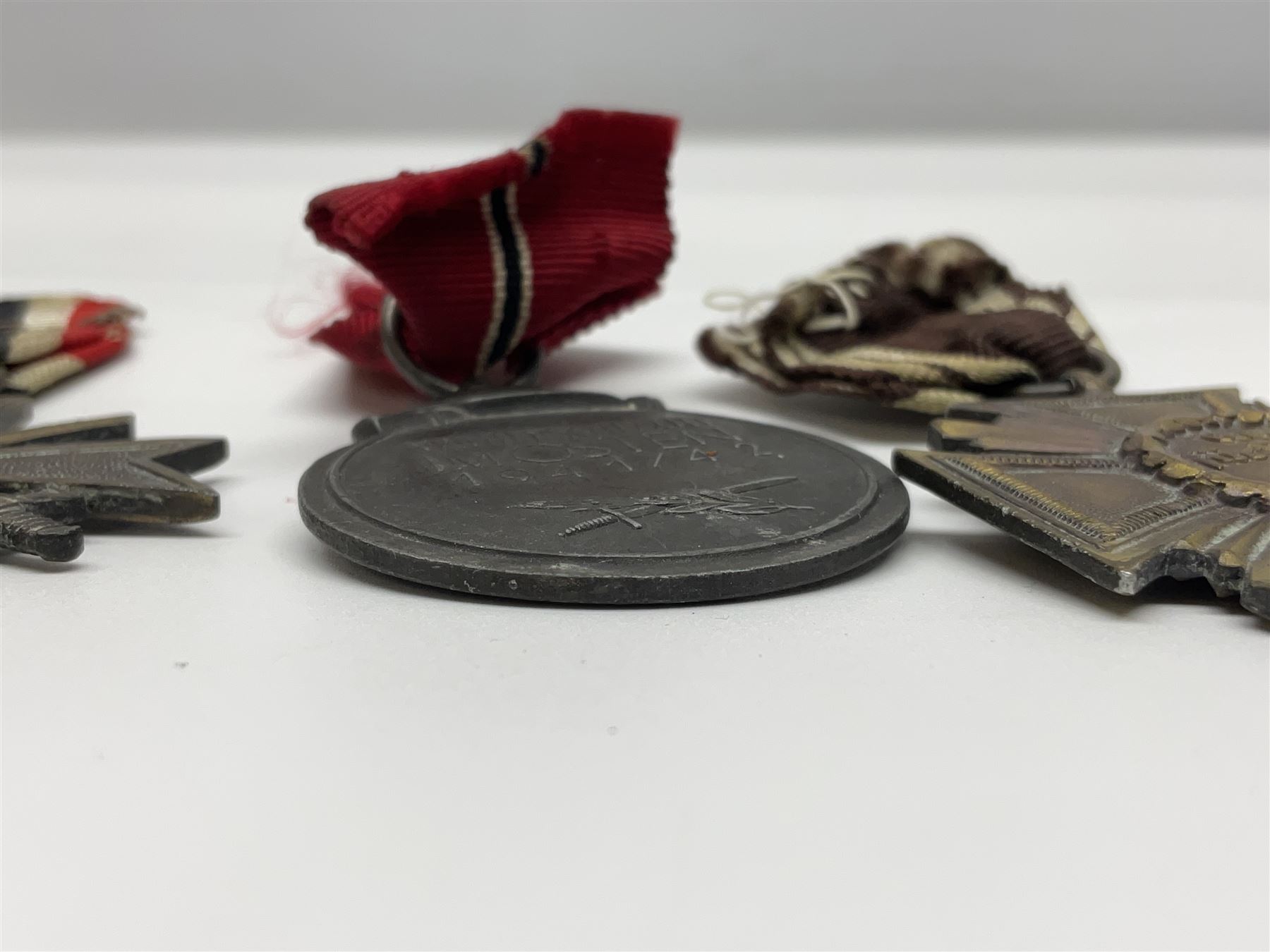 WW2 German Eastern Front Medal awarded to those who served on the German Eastern/Russian Front during the Winter Campaign period of 15th November 1941 to 15th April 1942 with original ribbon; German War Merit Cross with swords; and NSDAP Long Service Award (3)