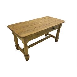 Stripped kitchen table, rectangular top with rounded edges, fitted with single drawer, raised on shaped supports united by stretcher