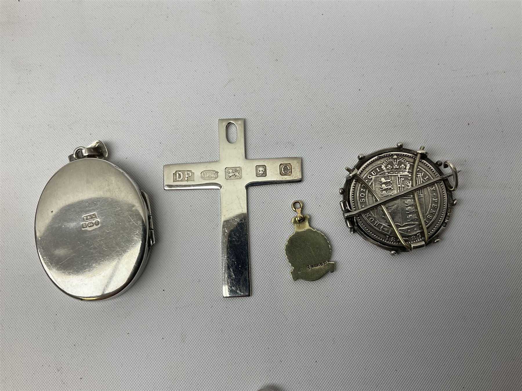 Modern silver locket, modern silver circular pendant, modern silver cross shaped pendant, small 9ct gold and enamel pendant, etc., approximate gross silver weight 40 grams, approximate gold weight 1.3 grams